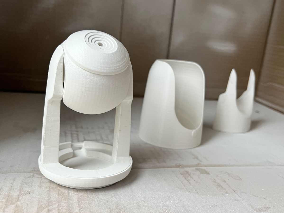 3D printed parts sitting in cardboard box for spray painting